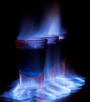 Burning drink in shot glass on a table