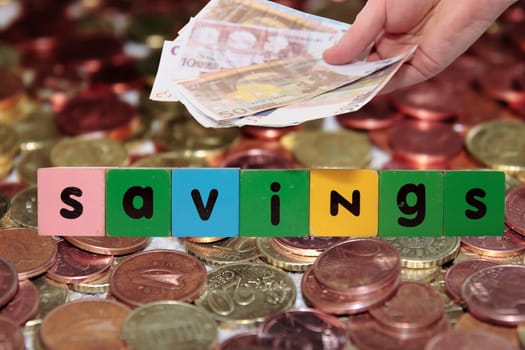 toy letters that savings against a money background with clipping path