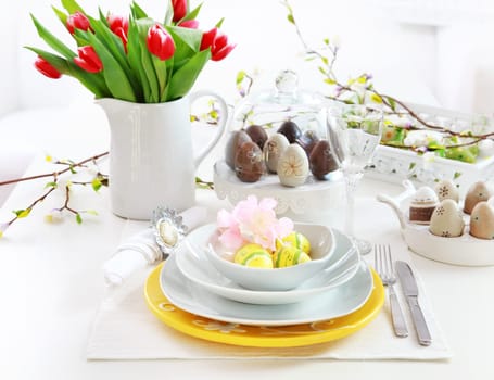 Place setting for Easter with eggs and tulips