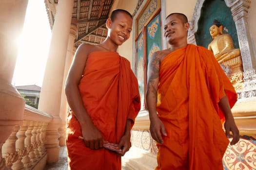 Two buddhist monks meeting and saluting in a temple, Phnom, Penh, Cambodia, Asia. Dolly shot