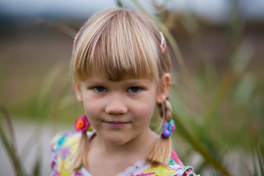 Portrait of a cute little girl outdoors on a spring day