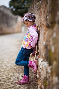 Portrait of a little girl outdoors on a city street