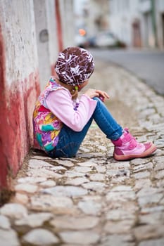 Portrait of a little girl outdoors on a city street