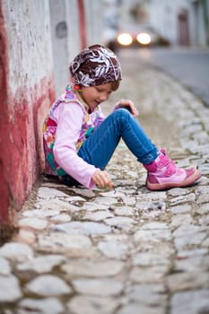 Portrait of a little girl outdoors on a city street