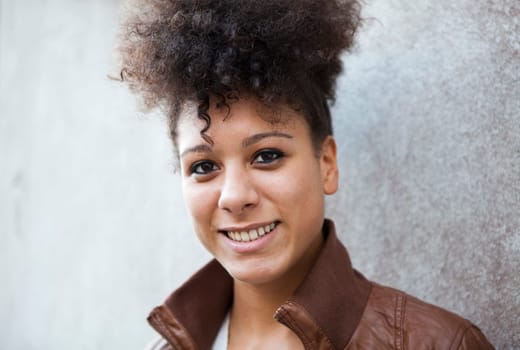 Portrait of a beautiful smiling young woman outdoors.