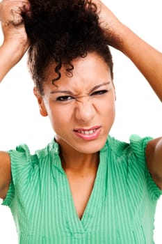 Woman pulling hair in frustration. Studio shot with isolated white background.