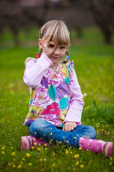 Cute little girl outdoors looking through imaginary binoculars