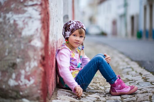 Portrait of a little girl outdoors on a city street
