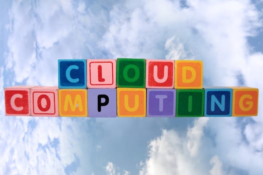 toy letters that spell cloud computing against a cloudy background with clipping path