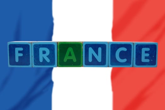 toy letters that spell france against a flag background with clipping path
