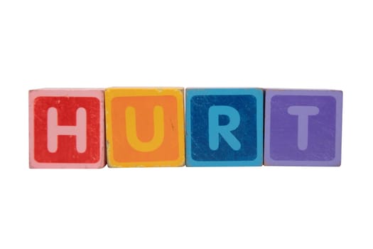 toy letters that spell hurt against a white background with clipping path