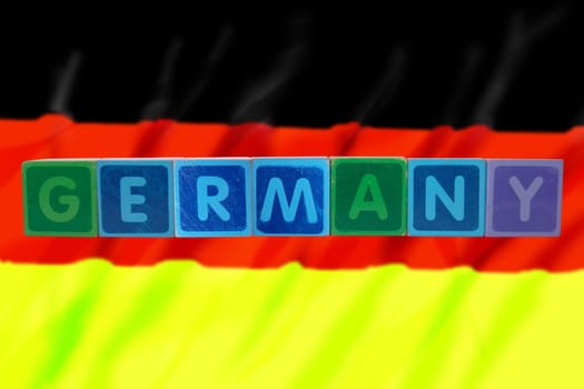 toy letters that spell germany against a flag background with clipping path