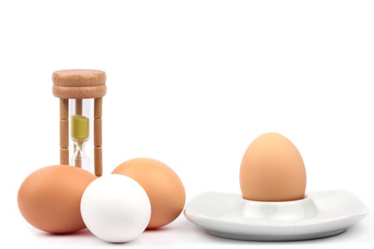 Chicken eggs with egg cup and egg timer