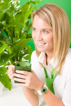Green business office woman drink coffee plant environment friendly smile