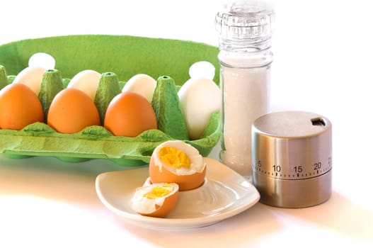 Chicken eggs with egg cup,salt mill and egg timer