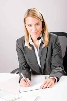 Customer service woman call operator phone headset sitting behind desk
