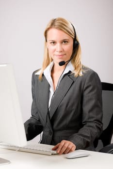 Customer service woman call operator phone headset working on computer