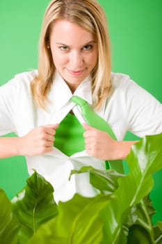 Superhero Businesswoman confident face green plants emerges from shirt