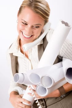 Smiling young female architect holding blueprints isolated on white background