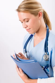 Attractive female doctor standing with stethoscope and folders isolated portrait