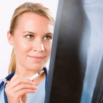 Young female doctor examining x-ray isolated on white background