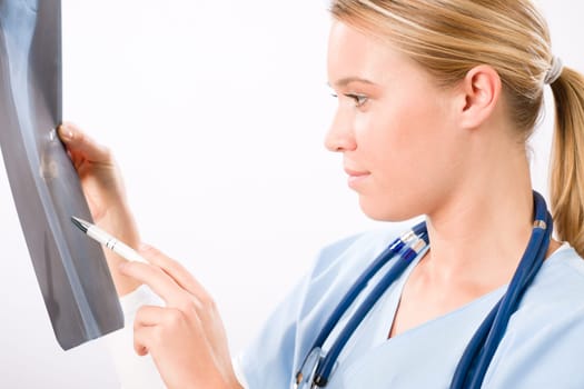 Young female doctor examining x-ray isolated on white background
