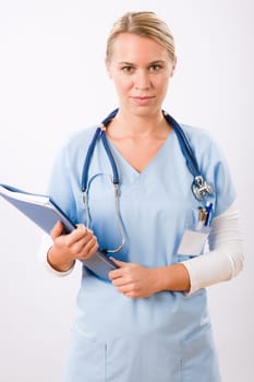 Attractive female doctor standing with stethoscope and folders isolated portrait