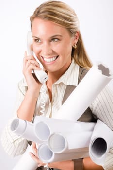 Smiling young female architect holding blueprints isolated on white background