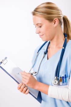 Attractive female doctor standing with stethoscope and folders isolated portrait