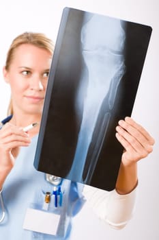 Young female doctor examining x-ray isolated on white background