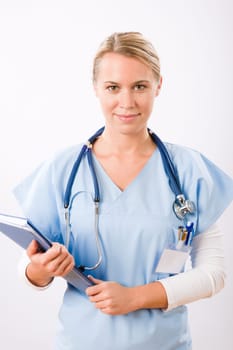 Attractive female doctor standing with stethoscope and folders isolated portrait