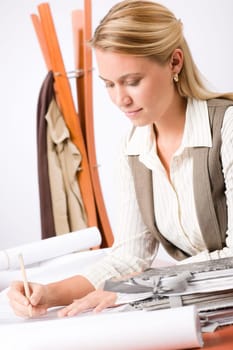 Female architect attractive working on a blueprint sketches in office