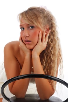Young blonde woman posing on a bar stool