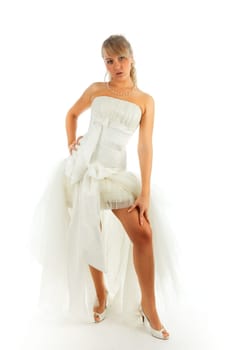 Young blonde woman posing in the bride dress