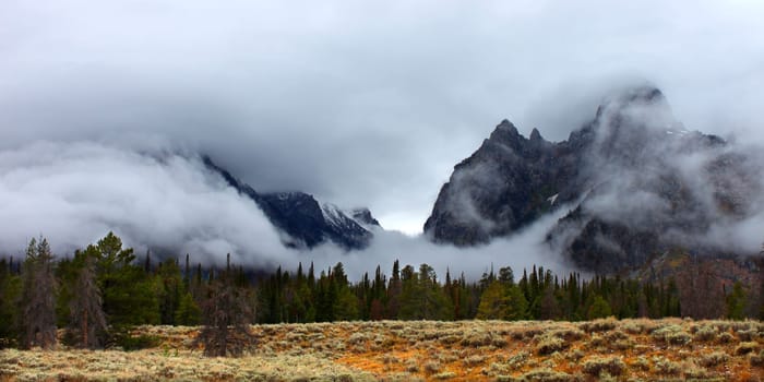 Clouds hang over jagged peaks of the Teton Range in western Wyoming