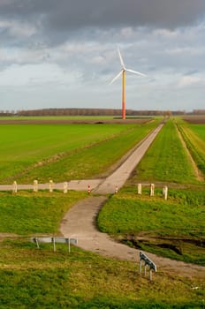 colorful windmill at the end of a small road in Almere, Netherlands