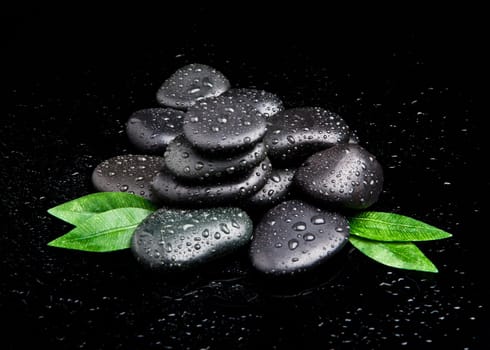 black stone with leaf. massage stones