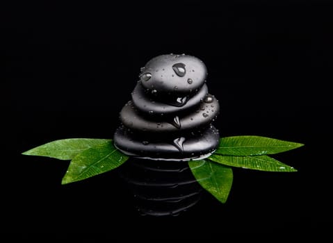 black stone with leaf. massage stones