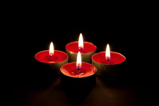 Four flaming red candles