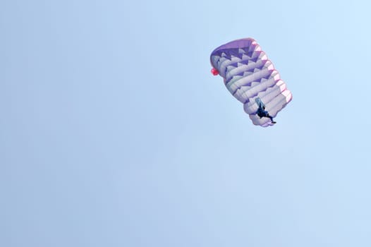 A parachute over a blue sky background