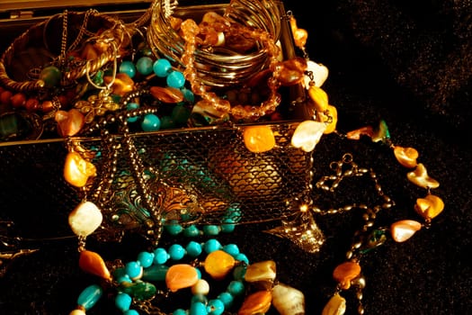 Old looking jewellry in a silver box on a black fur