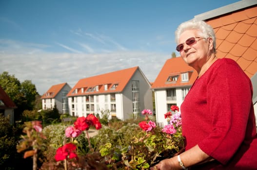 Senior woman sunbathing on the balcony