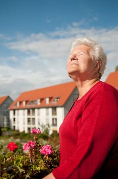Senior woman sunbathing on the balcony
