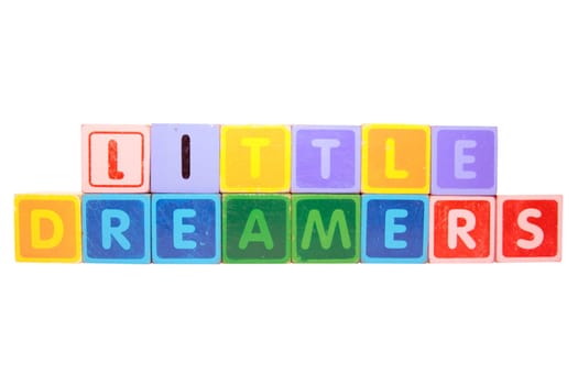 toy letters that spell little dreamers against a white background with clipping path