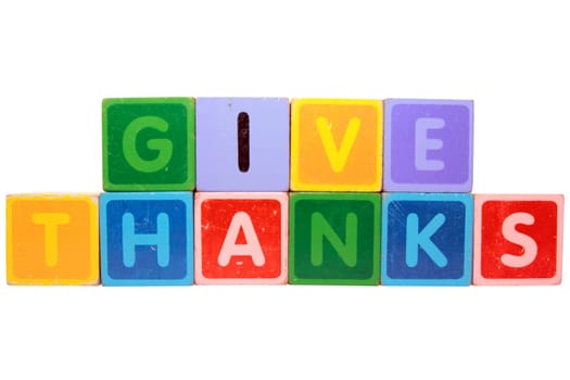 toy letters that spell give thanks against a white background with clipping path