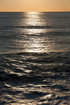 reflections on the waves of the sea at sunset