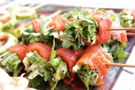 Vegetable wrapped in meat