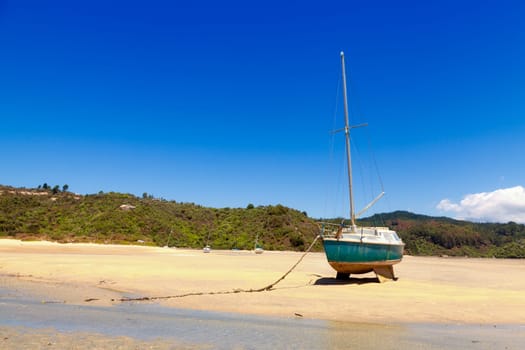 Sailboats sitting on the ground during low tide in Tasman Bay in New Zealand