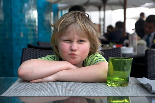 Boy grimaces