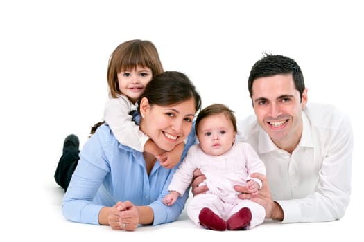 Portrait of young couple having fun with their daughters. Isolated on white background.